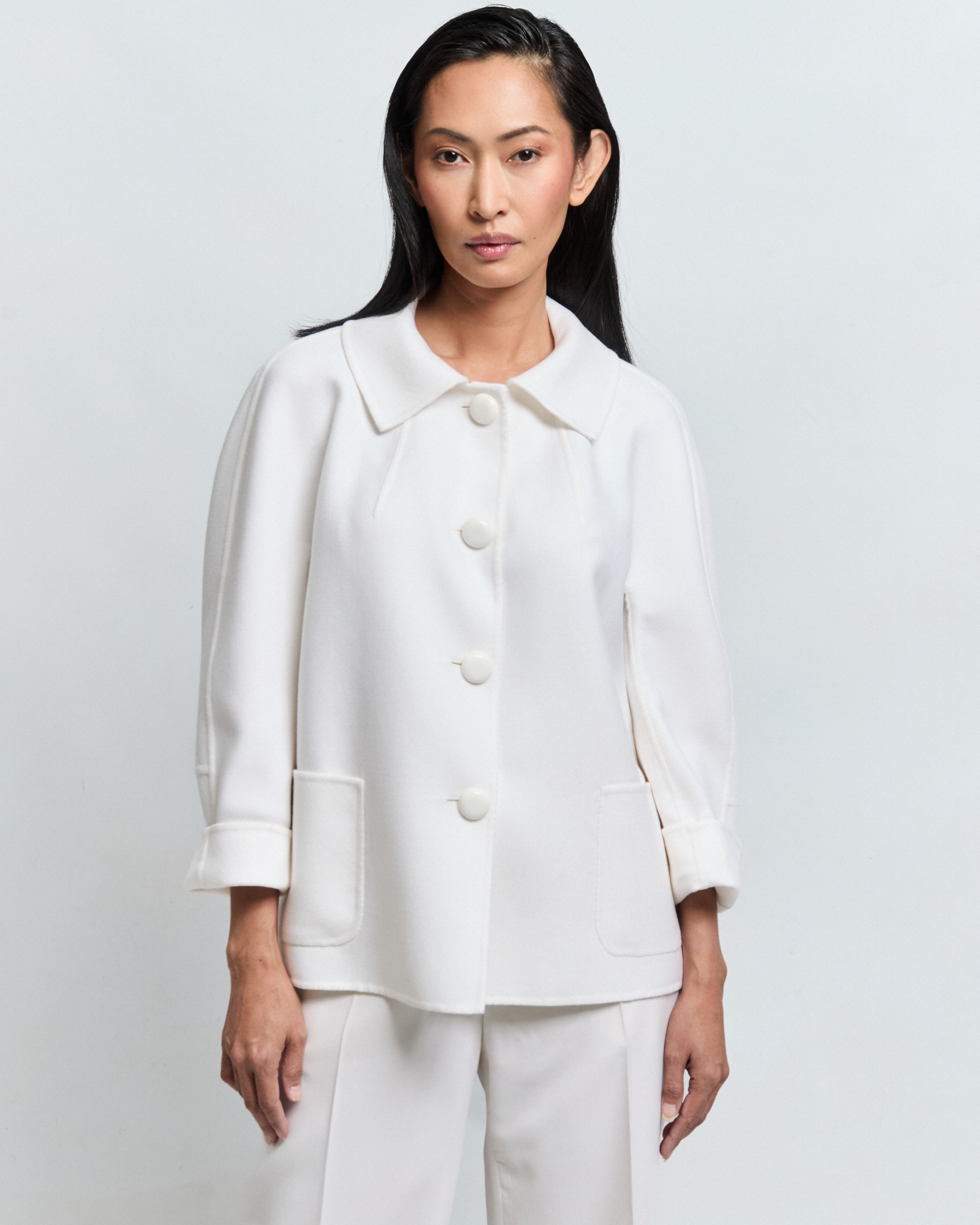 · CORIN double merino wool jacket with boucle collar, kimono silhouette — Pohjanheimo · Detail of CORIN jacket — three-button front and boucle collar finish · CORIN merino jacket styled with silk trousers — Pohjanheimo Tallinn